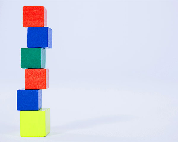 A stack of child's blocks illustrating Google SEO Essential Building Blocks